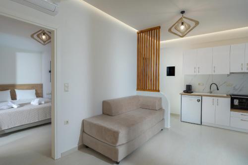 a living room with a couch and a bed and a kitchen at Amara Seaside by Estia in Malia