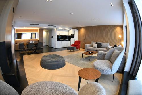 a living room with a couch and chairs and a table at Faqra Hills Hotel in Kfardebian