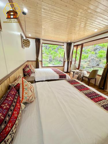 a bedroom with two beds on a boat at Mèo Vạc Beehive House in Mèo Vạc