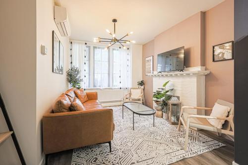 a living room with a couch and chairs and a fireplace at Downtown Oasis-2BR-Spa Bath-Pet Friendly, Free Parking in Toronto