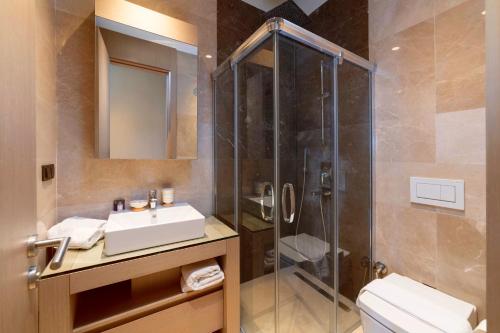 a bathroom with a shower and a sink and a toilet at Root Redrock Yalıkavak in Yalıkavak