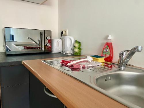 a kitchen counter top with a sink and a sink at Apartments Skyreach in Essen