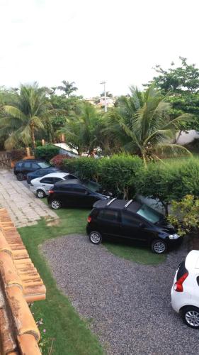 a row of cars parked in a parking lot at Pousada Barcarola in Búzios