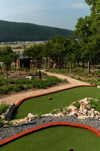 a garden with a green lawn and a playground at GRANÁRIUM in Jablonov nad Turnou