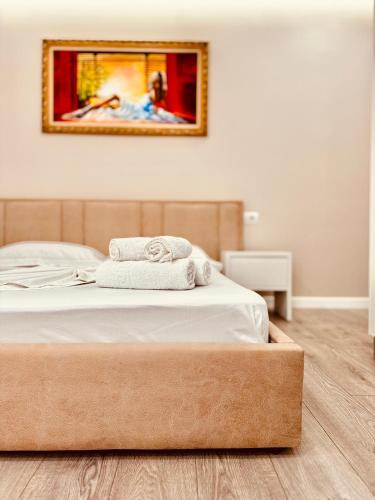 a bedroom with a bed with two towels on it at Villa Merkuri in Himare