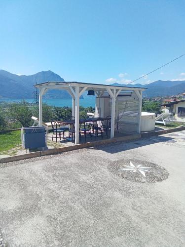 a gazebo with a table and chairs in it at Cà Negra Ca negra suite in Costa Volpino