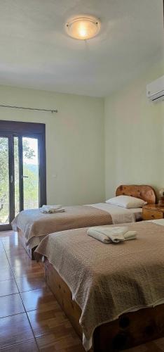 a room with three beds in a room at Villa Nikos in Agios Dimitrios