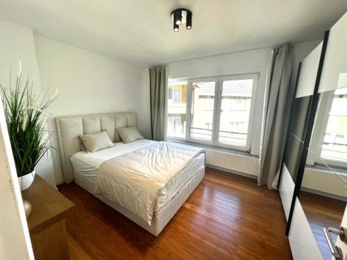 a bedroom with a bed and a large window at Wolu suites in Brussels