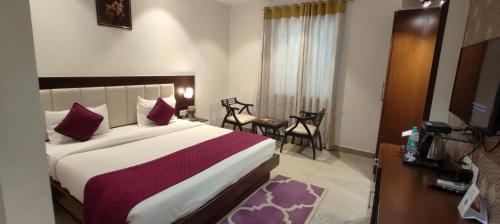 Postel nebo postele na pokoji v ubytování Hotel Taj Heights