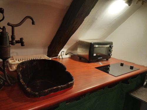 a desk with a microwave and a television on it at Rustic Charm a Unique and Antique Apartment in Zagreb