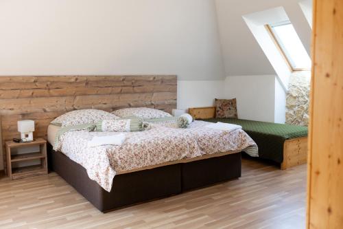 a bedroom with a large bed with a wooden headboard at GRANÁRIUM in Jablonov nad Turnou