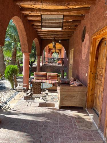 an outdoor patio with a table and chairs at Chez Mamouchthka in Ourika