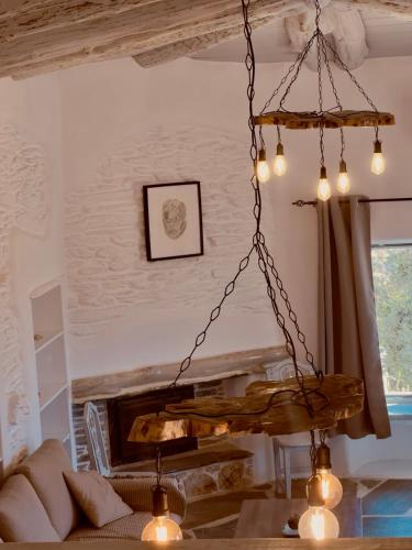 a chandelier hanging from the ceiling in a living room at Richie's Sea View Romantic Residences in Andros