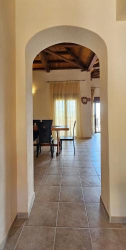 an archway in a living room with a table at Villa Dimitra in Agios Dimitrios