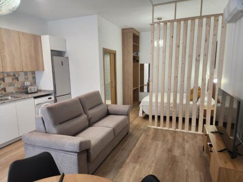 a living room with a couch and a kitchen at Dormavalencia Crónica in Valencia