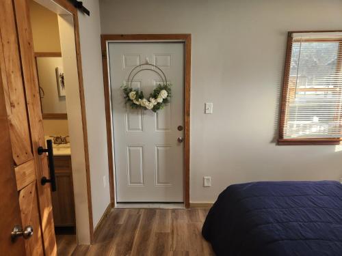 a bedroom with a door with a wreath on it at Beach Bum West-O Cabins in Ocean City