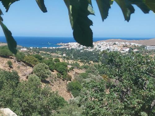 a view of a town on a hill near the ocean at Richie's Sea View Romantic Residences in Andros
