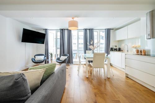 a living room with a couch and a table at Welcome London - The Piazza in London