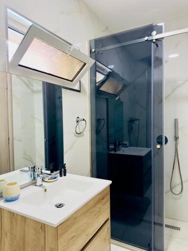 a bathroom with a sink and a shower at Villa Merkuri in Himare