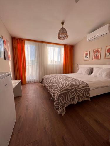 a bedroom with a bed with a zebra blanket on it at BiSuite Urla in Kuscular
