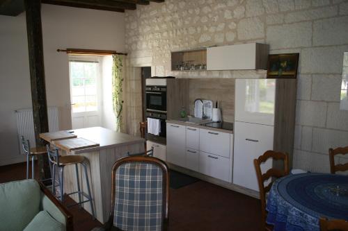 a kitchen with white cabinets and a counter top at Grand gite en rez-de-jardin in Saint-Aignan