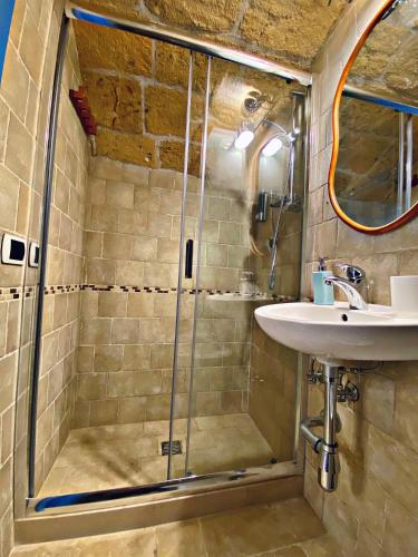 a bathroom with a shower and a sink at Essential in Polignano a Mare