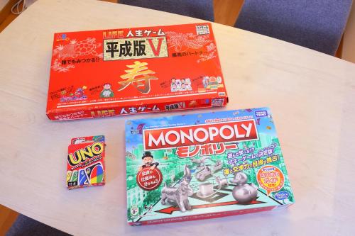 a table with two games and a box of monopoly at Rose Garden in Asahikawa