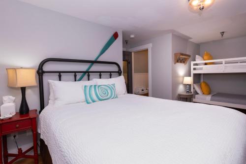 a bedroom with a large white bed and a red table at Chapter House in Yarmouth