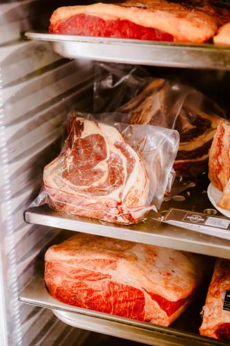 a refrigerator filled with lots of different types of meat at Escua in Archidona