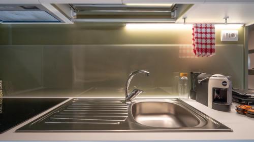 a kitchen sink with a faucet in a kitchen at Agricamping Ai Prati in Lazise