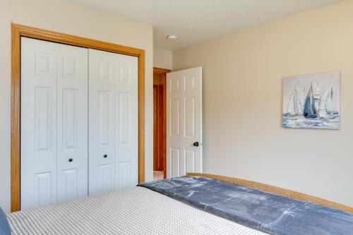 a bedroom with a bed and two white doors at Roomy Piedmont Home with Yard Less Than 14 Mi to Sturgis! in Piedmont