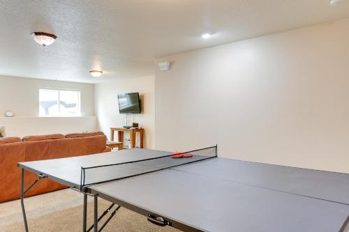 a ping pong table in a living room with a couch at Roomy Piedmont Home with Yard Less Than 14 Mi to Sturgis! in Piedmont