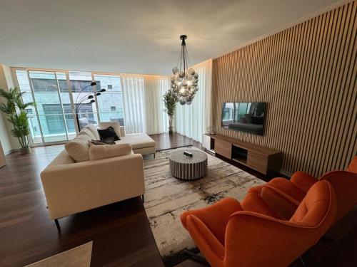 a living room with a couch and a tv at Funchal Next Corner Plaza in Funchal