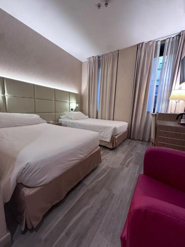 a hotel room with two beds and a couch at Best Western Cavalieri Della Corona in Cardano al Campo