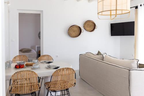 a living room with a couch and a table and chairs at Felicia Exclusive Villa - Private Pool in Arnados