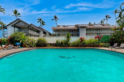 a swimming pool in front of a house at Kona Ali'i 502 in Kailua-Kona