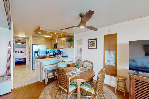 a kitchen and dining room with a table and chairs at Kona Ali'i 502 in Kailua-Kona