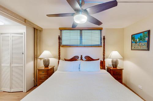 a bedroom with a bed with a ceiling fan at Kona Ali'i 502 in Kailua-Kona