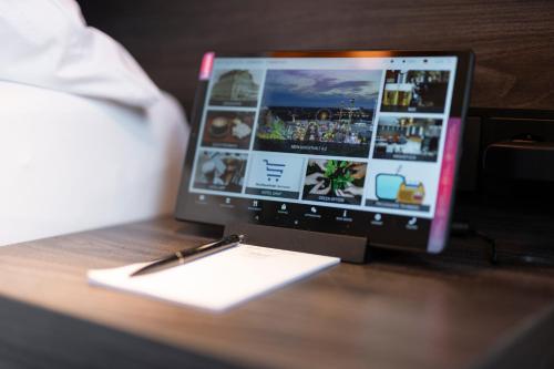 a laptop computer sitting on top of a wooden table at Boutique Hotel Germania in Munich