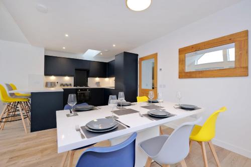a dining room and kitchen with a white table and chairs at Contemporary Luxury Lodge, Aberdeen West in Blackburn