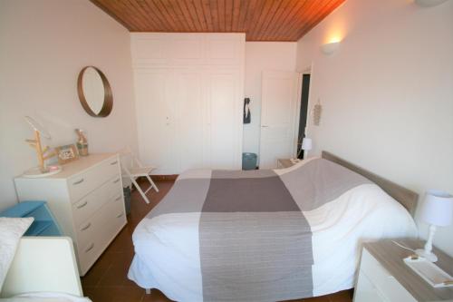 une chambre avec un lit, une commode et un miroir dans l'établissement Agréable maison à pied de la plage et du centre avec wifi, à La Tranche-sur-Mer