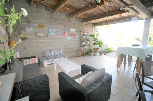 un salon avec un canapé, des chaises et une table dans l'établissement Agréable maison à pied de la plage et du centre avec wifi, à La Tranche-sur-Mer