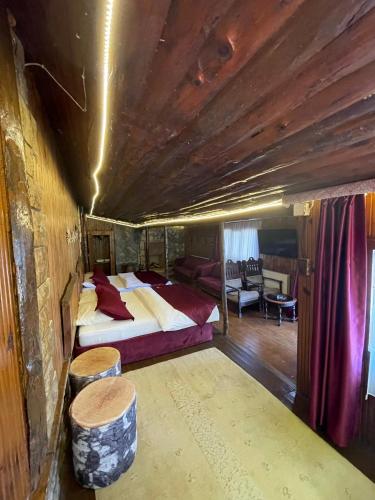 a bedroom with a bed and a table and a couch at Paradise Plus Ağva in Agva