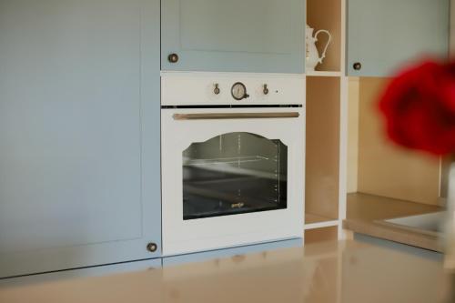 a kitchen with a white oven in a cabinet at Greenyard in Čapljina