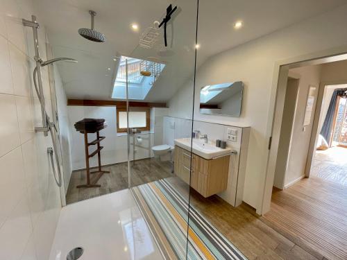 a bathroom with a shower and a sink at Chiemsee Living in Chieming