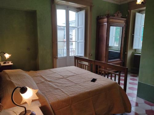 a bedroom with a bed and two windows at B&B Don Antonio in Civitella Casanova