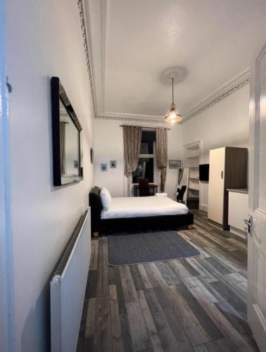 a hotel room with a bed and a desk at Queens Park Studio in Glasgow