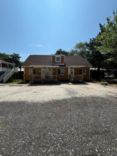 a large house with a driveway in front of it at Beach Bum West-O Cabins in Ocean City