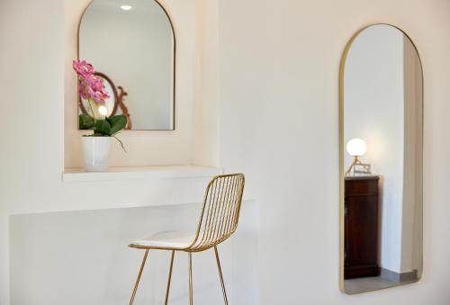 a chair in a room with two mirrors at Residenza D'epoca Tamara in Castellabate