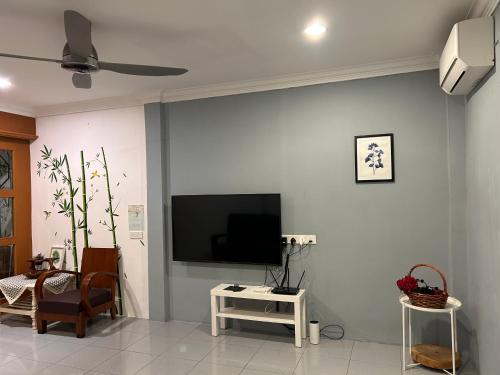 a living room with a flat screen tv on a wall at Terap Homestay 500MB Wi-fi in Sibu